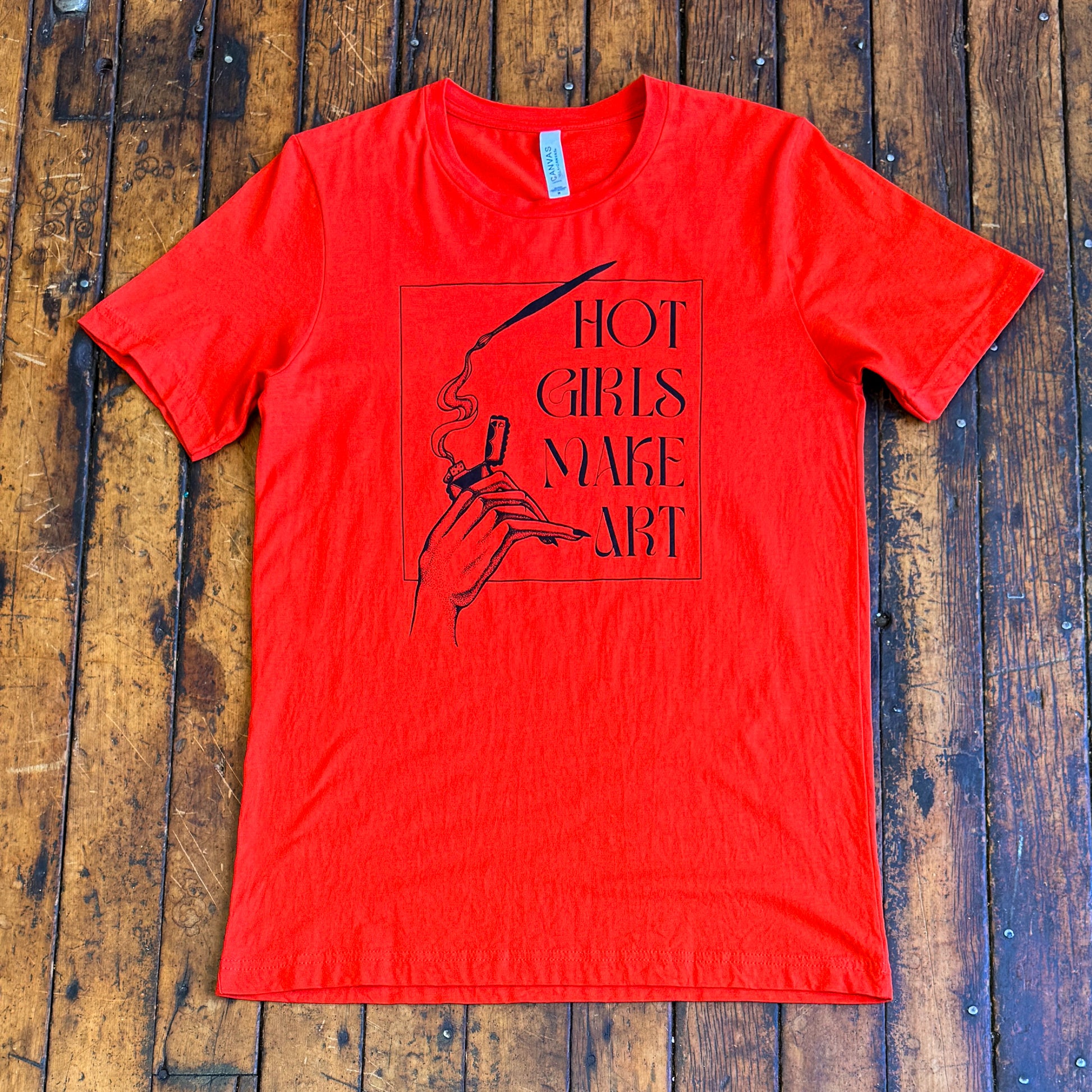 red tee shirt that says hot girls make art on the front with a hand holding a zippo lighter and smoke paint coming out of a paintbrush